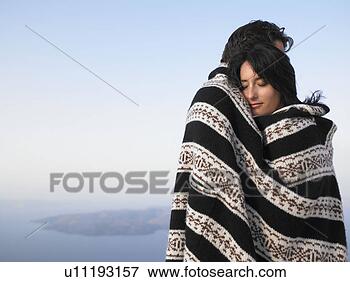 Picture - couple wrapped 
in a cover, hugging. 
fotosearch - search 
stock photos, 
pictures, wall 
murals, images, 
and photo clipart
