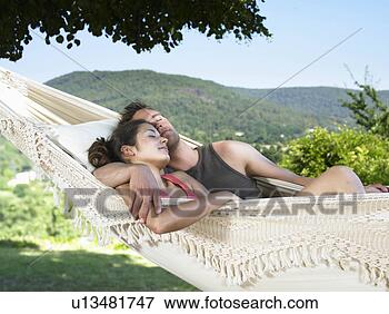 Picture - couple asleep 
on hammock. fotosearch 
- search stock 
photos, pictures, 
wall murals, images, 
and photo clipart