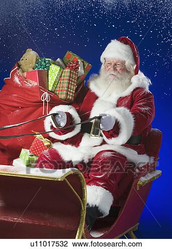 Stock Photo - santa claus in  sleigh with bag  of toys. fotosearch  - search stock  photos, pictures,  wall murals, images,  and photo clipart