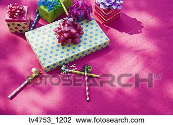 Stock Photo - birthday gifts and noise makers on table. fotosearch - search stock photos, pictures, images, and photo clipart