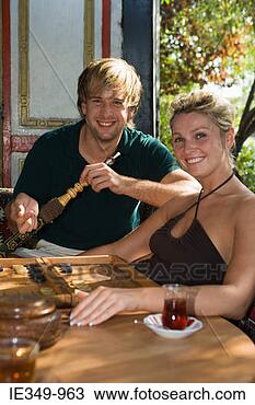 Stock Photo - couple with hookah  and backgammon.  fotosearch - search  stock photos,  pictures, images,  and photo clipart