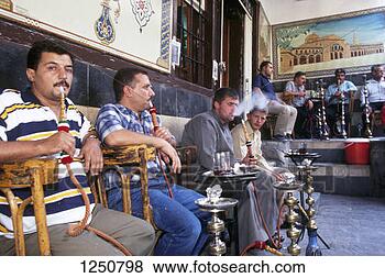 Stock Photo - men sitting outside  a cafe in the  old city smoking  hookahs. fotosearch  - search stock  photos, pictures,  images, and photo  clipart