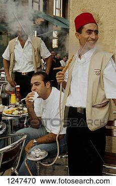 Stock Photography - men smoking and  eating outside  a cafe, beirut,  lebanon. fotosearch  - search stock  photos, pictures,  images, and photo  clipart