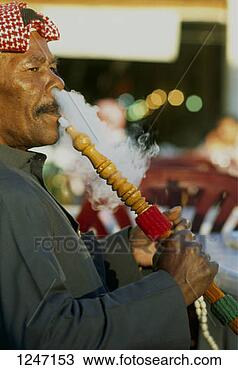 Stock Photo - a man smoking  a hookah, kuwait.  fotosearch - search  stock photos,  pictures, images,  and photo clipart