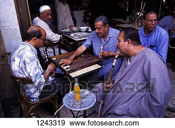 Stock Photograph - men playing backgammon  and smoking shishas  at a cafe in the  bab al. fotosearch  - search stock  photos, pictures,  images, and photo  clipart